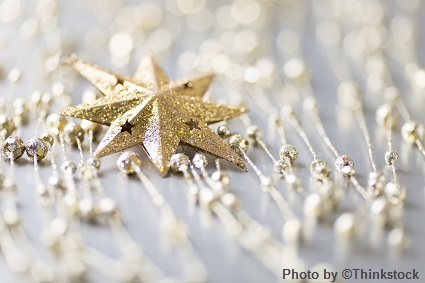 M10G A golden glittered star ornament with smaller surrounding ornaments