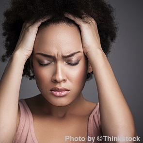 M3H A woman holds her head with her hand with eyes closed