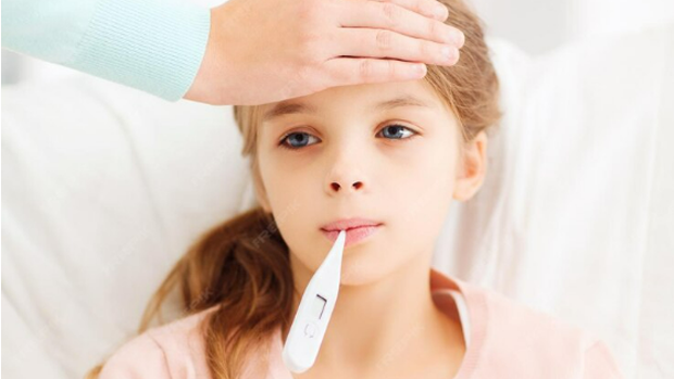 Girl with thermometer in her mouth