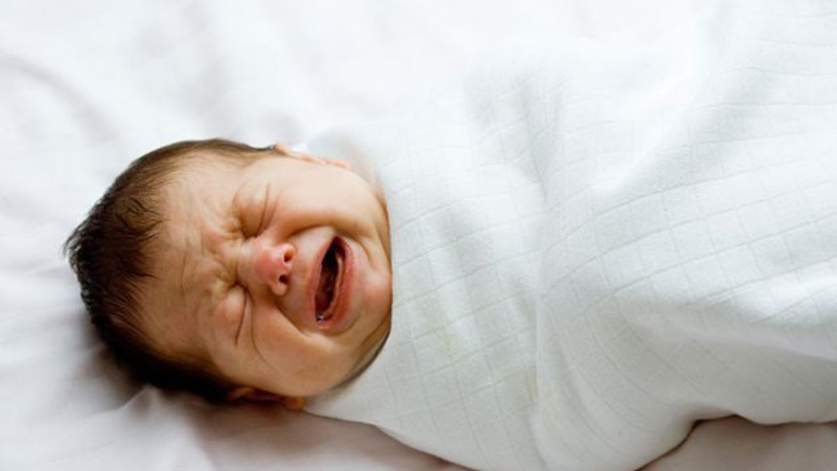 Newborn crying, illustrating neonatal abstinence syndrome from prenatal opioid exposure.