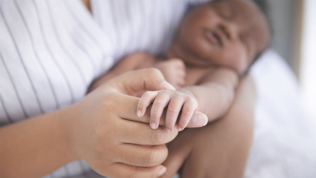 A woman holding a newborn