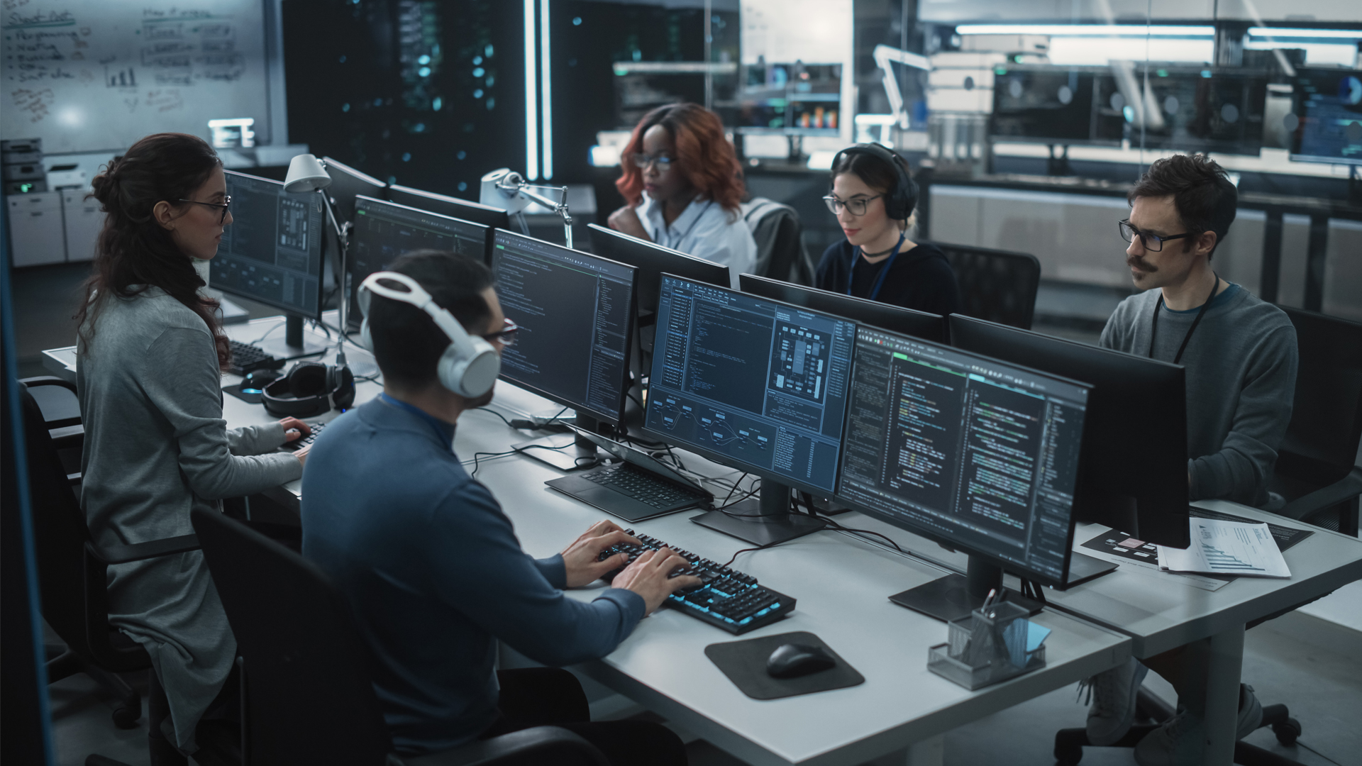 five readiness and response professionals work together at computers
