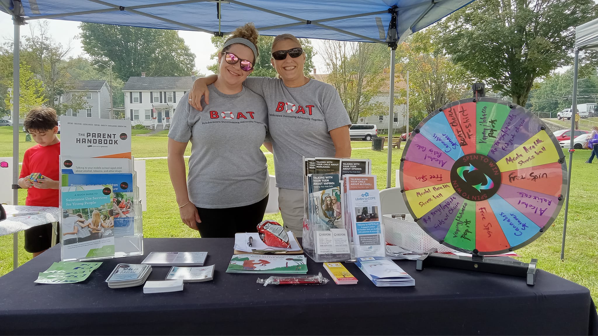 DFC-BelchertownStory-Thumbnail Two adults staffing the BOAT coalition table at community event