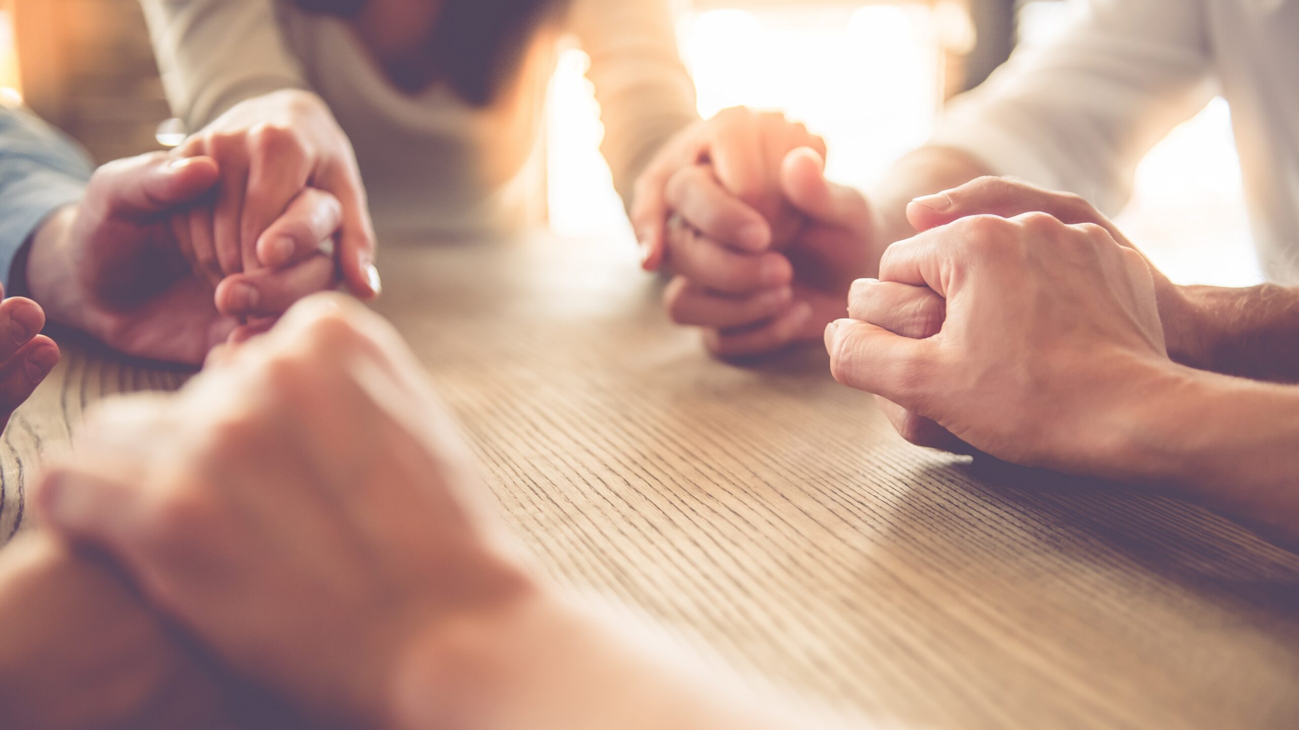 people holding hands in a circle.