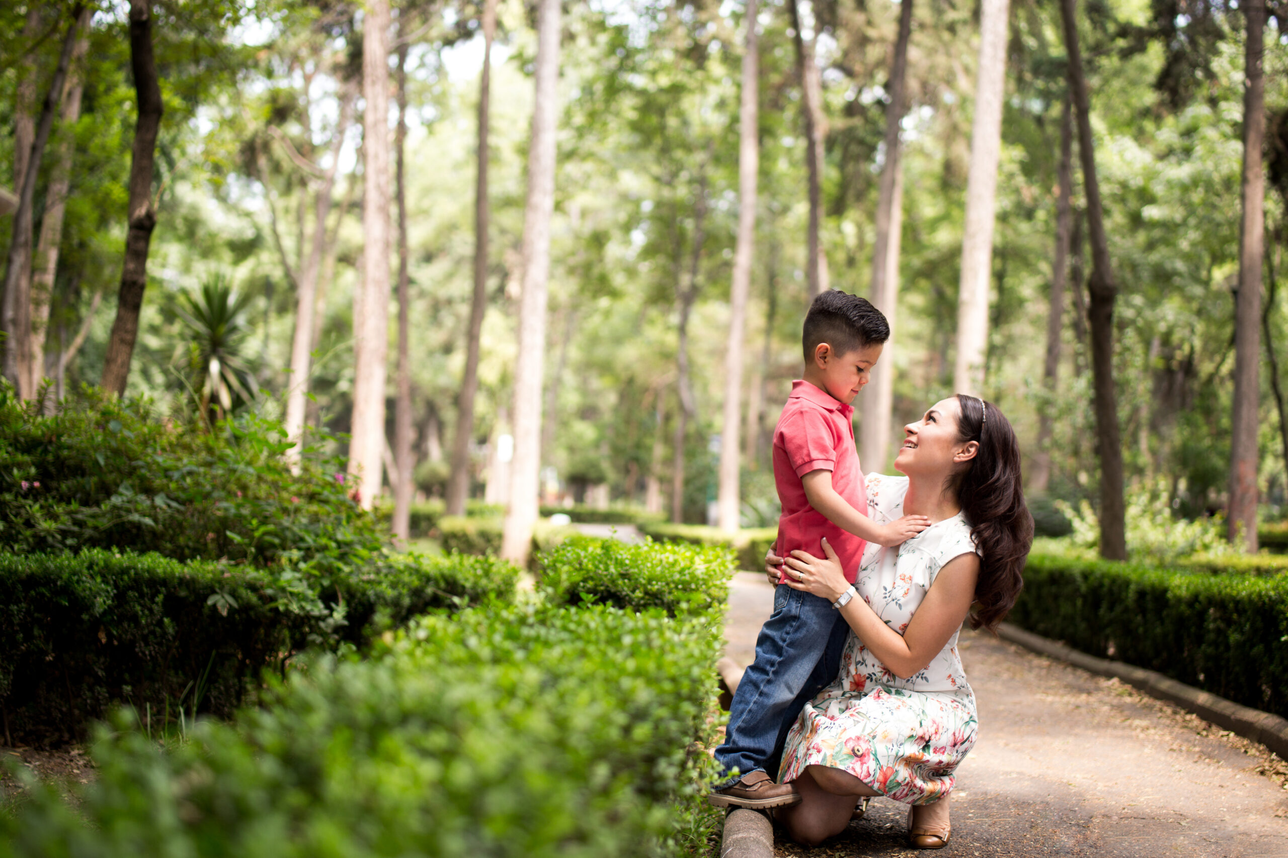 Mom crouched down talking to young boy