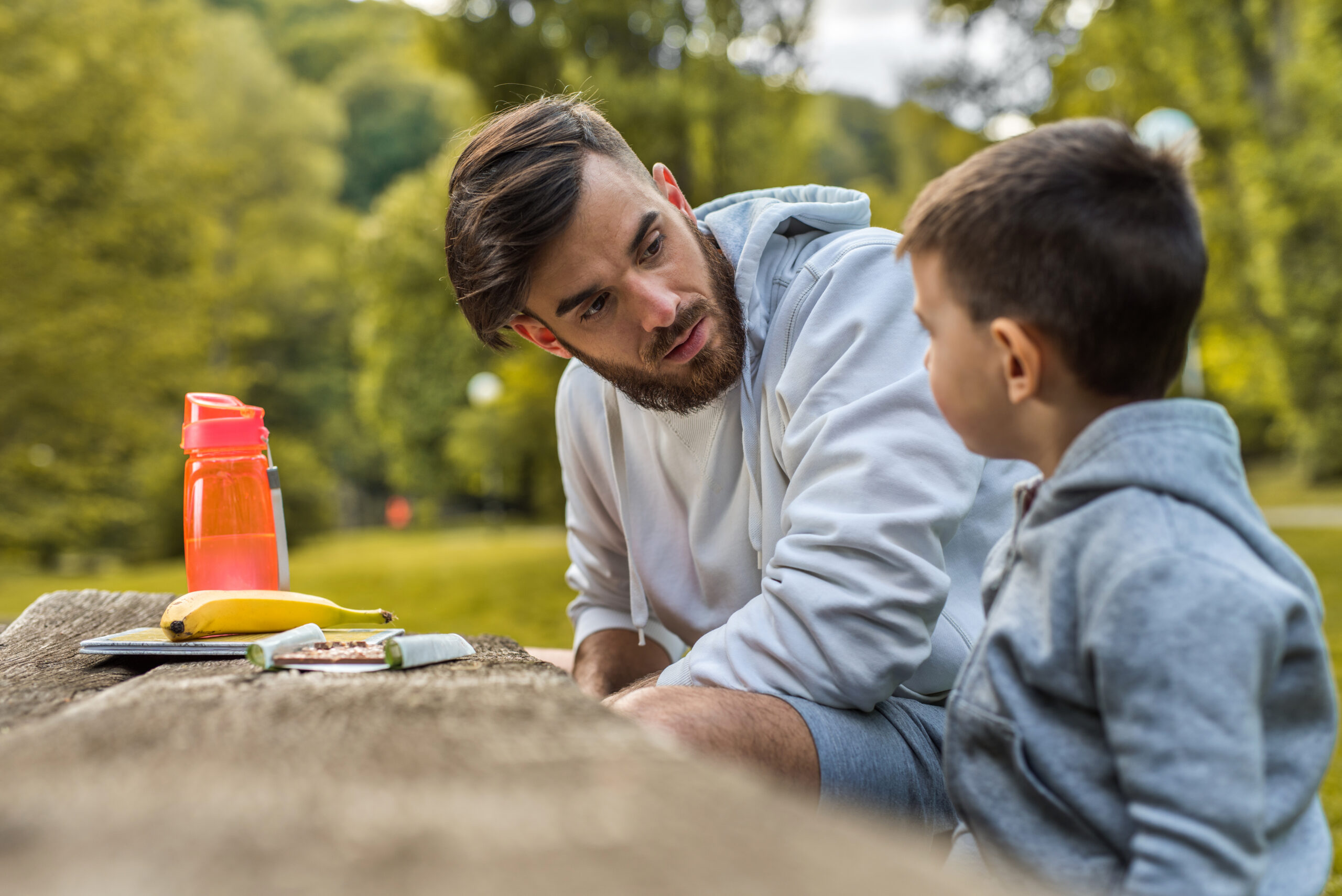 Dad and toddler son talking