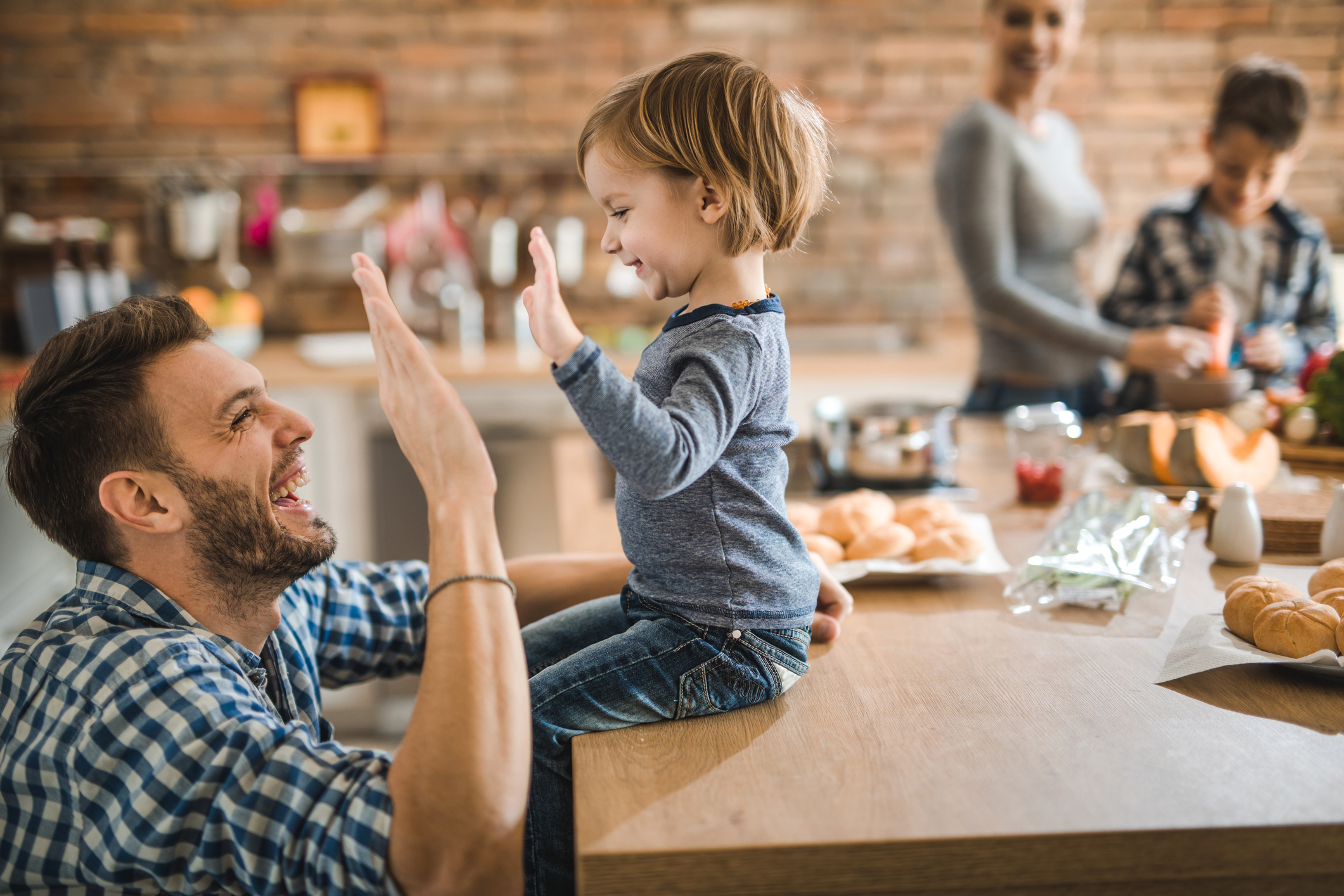 Dad high-fiving toddler son