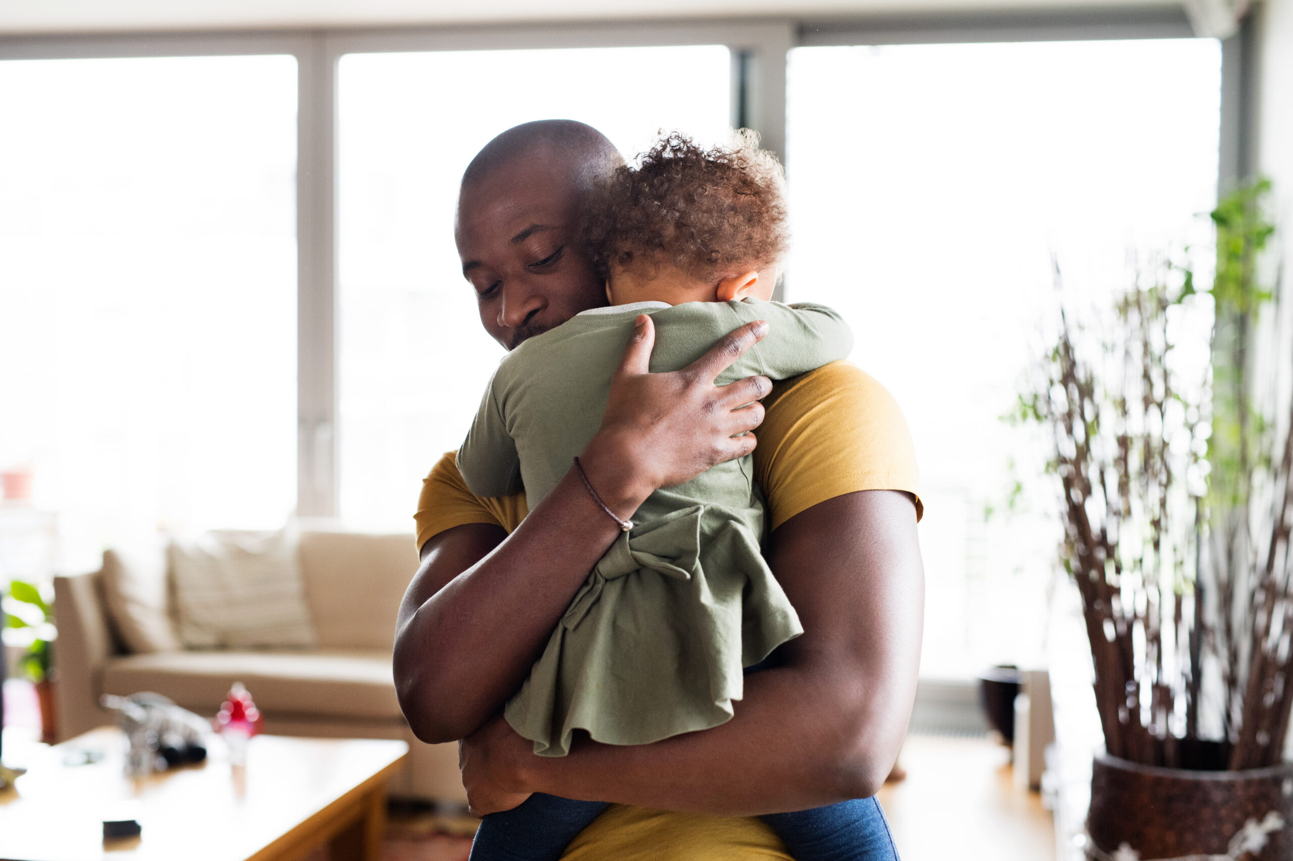 Dad comforting toddler daughter