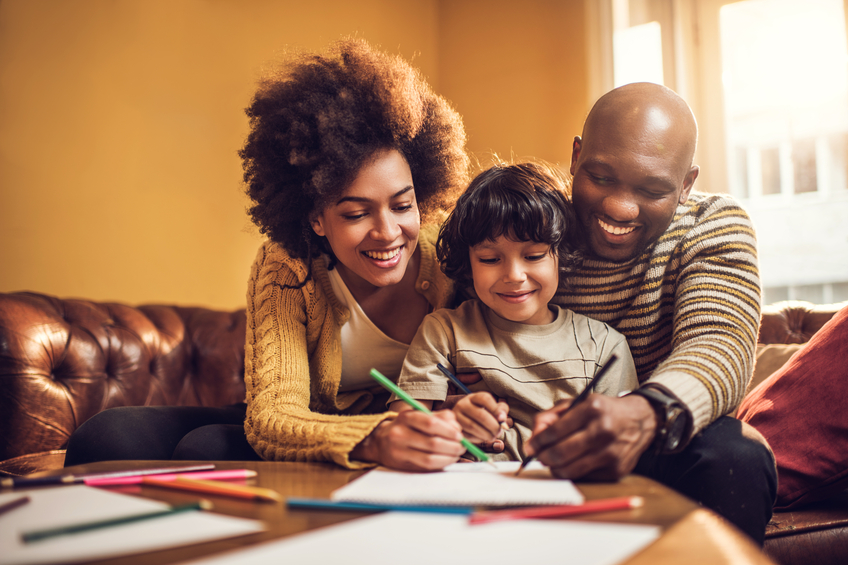 Mom and dad coloring with young child