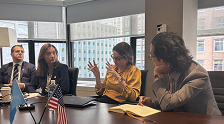 Michael Craig, Dawn Sievert, and Fernanda Lessa, and Ben Park sitting in office holding a meeting.