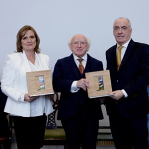 Orlaith and Ciaran Staunton with the President of Ireland, Michael D. Higgins, receiving the 2022 Presidential Distinguished Service Award