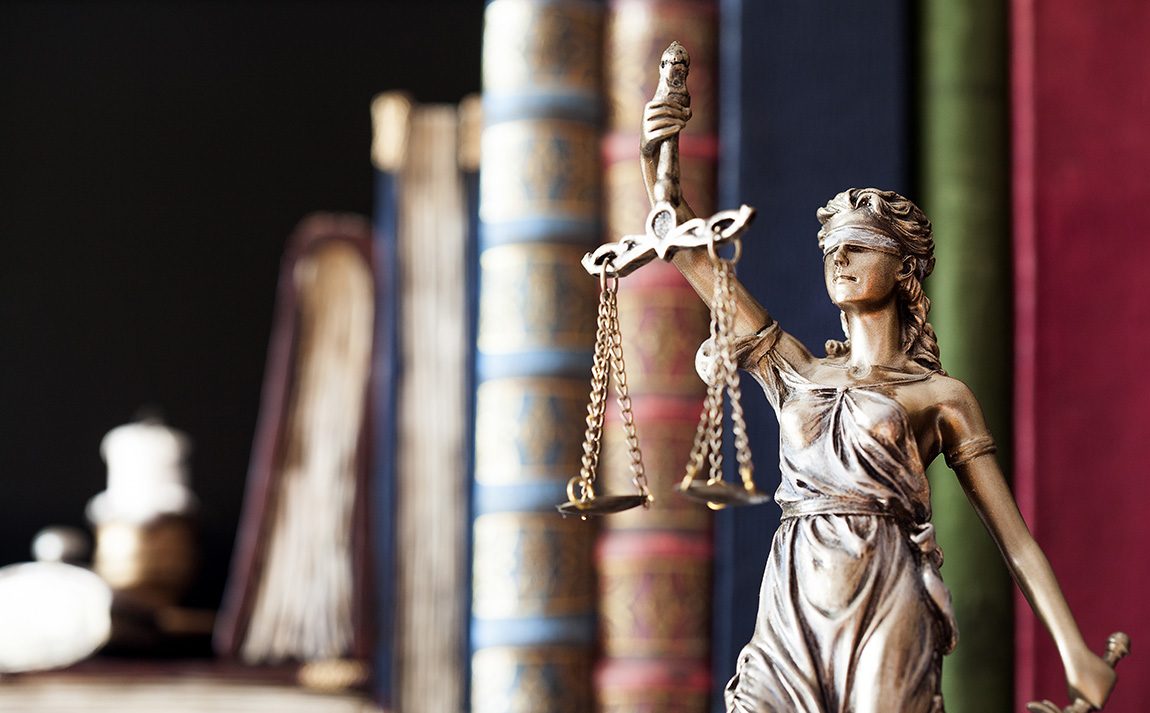 phlp022022main.jpg Scales of justice with books in the background.