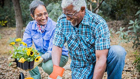 gardening is a great way to add physical activity to your day. Older couple gardening outside.