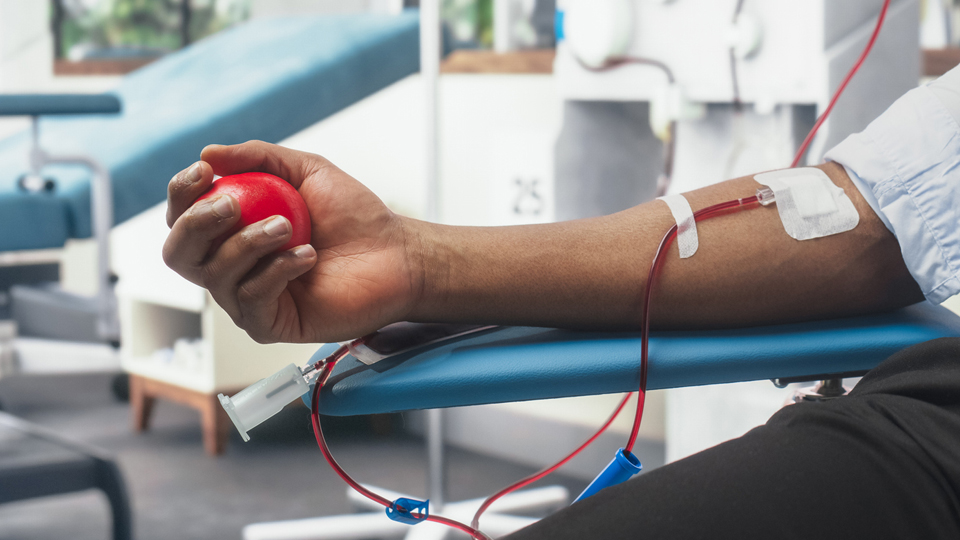 get involved Black man donating blood.