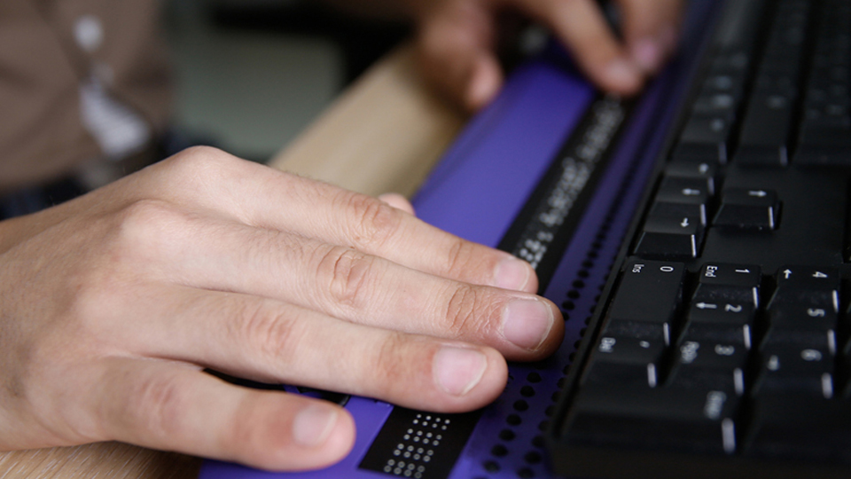 improve access Close-up of white male hands typing on a computer keyboard.