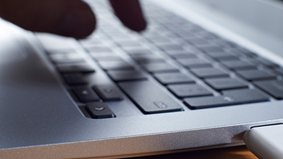 paperwork Close up image of hands typing on a laptop computer.
