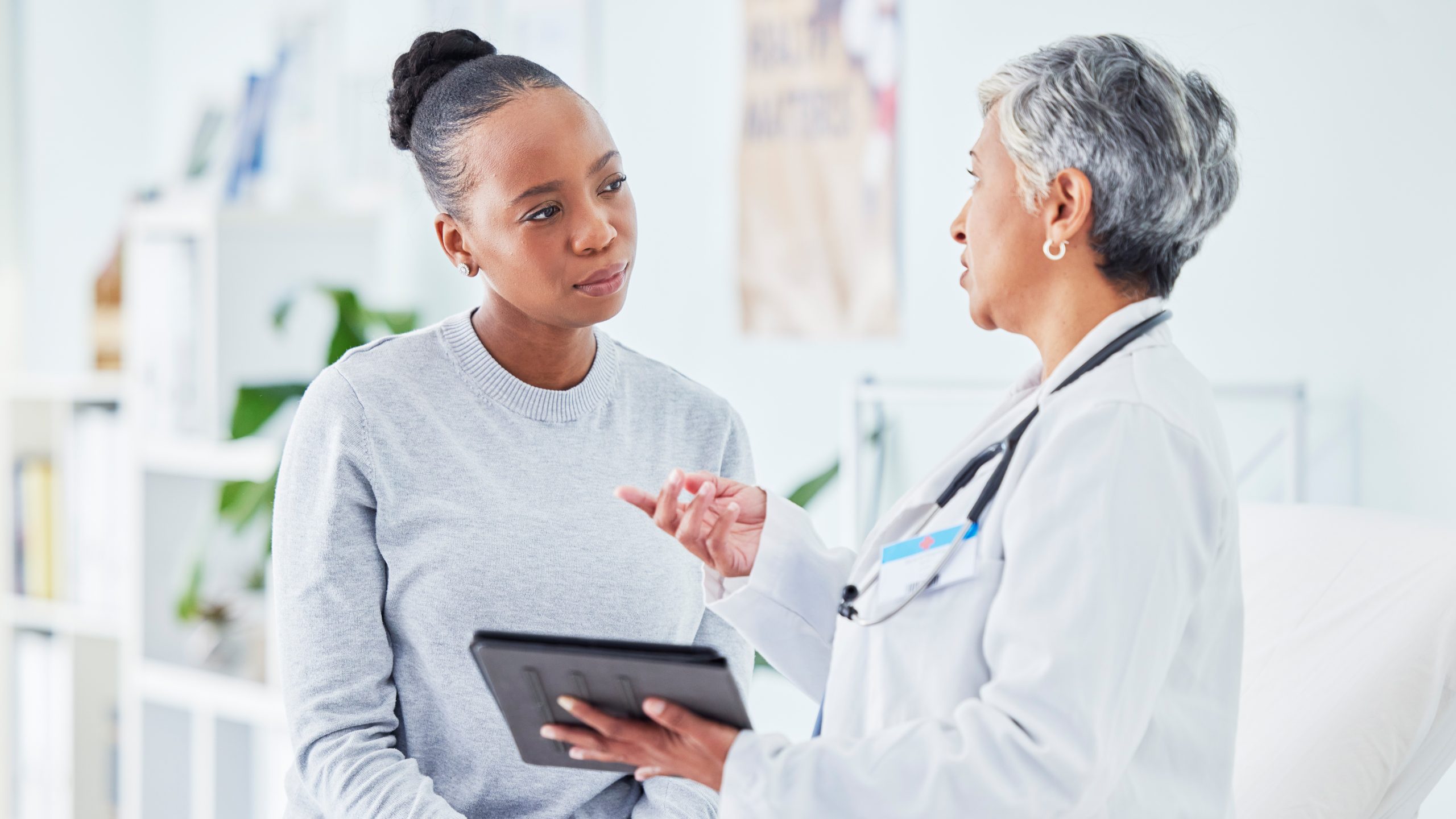 Woman consulting with her clinician Patient consulting with their physician