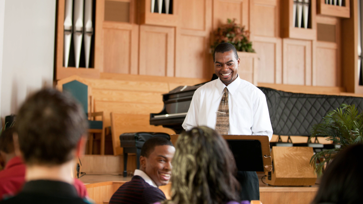 Faith leader standing in front of his congregation