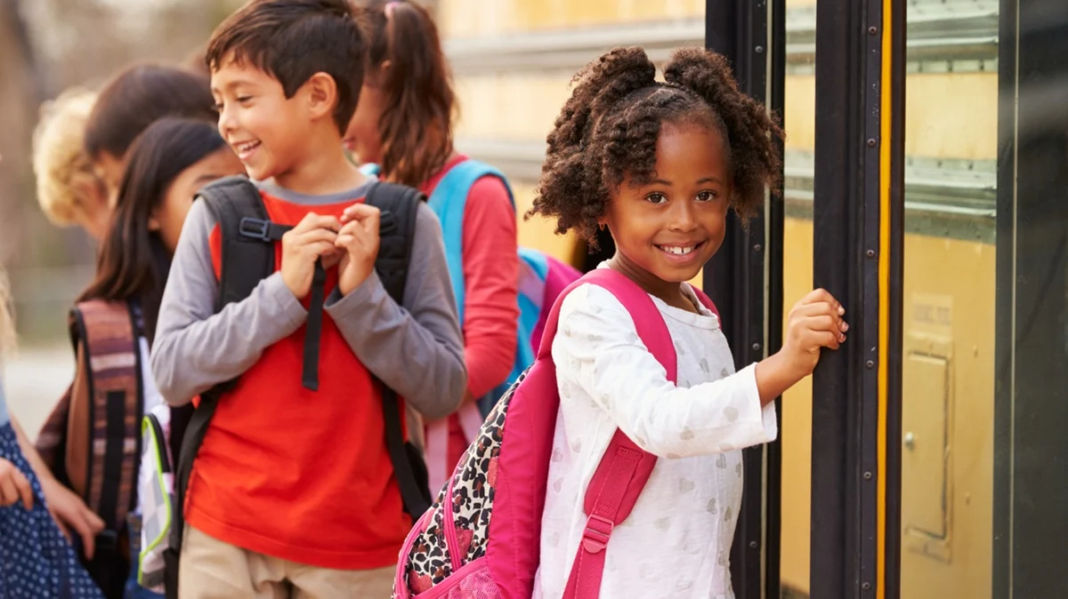 Young girl about to get on the school bus.