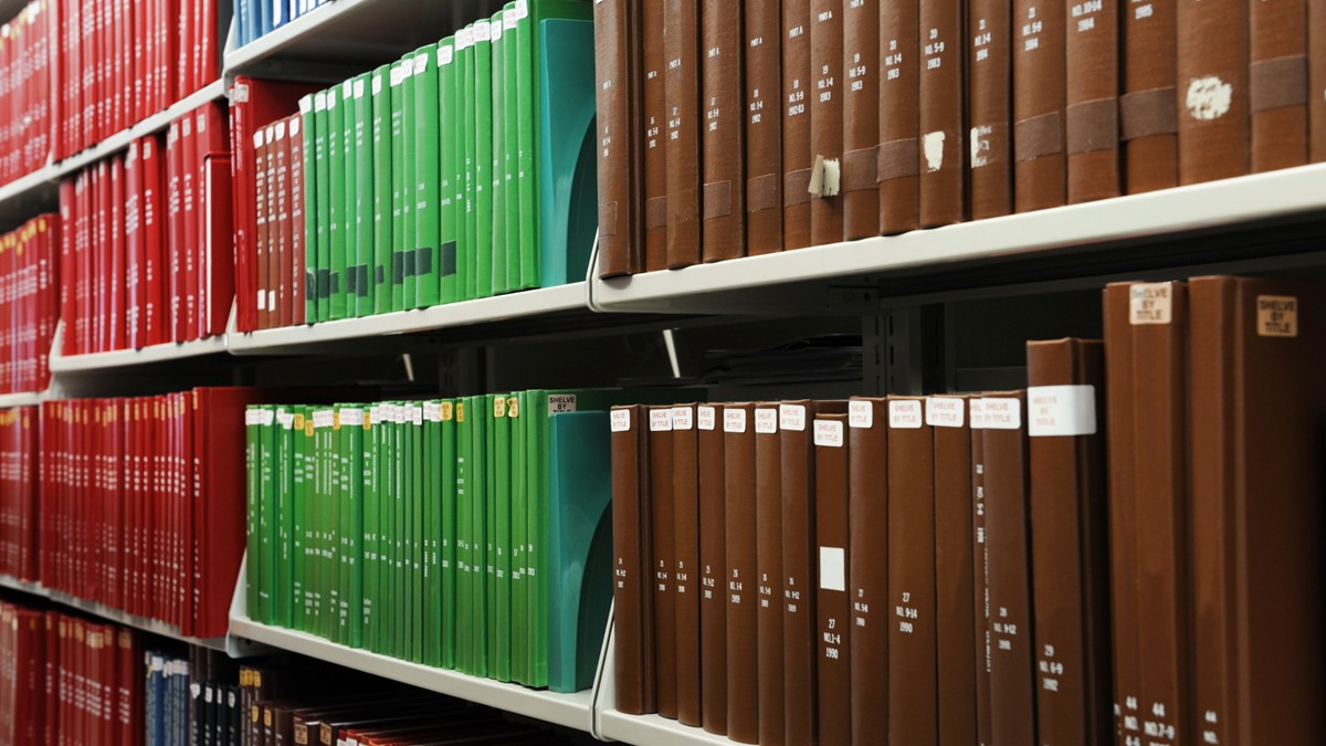 A perspective view of five shelves in a library.