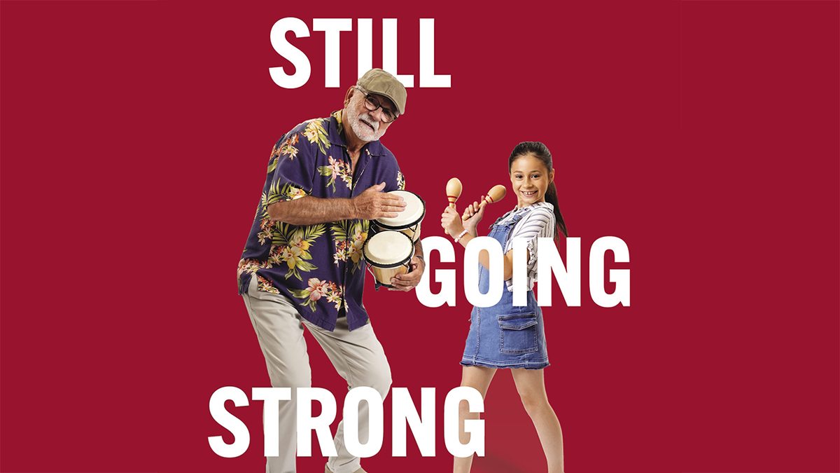 An older man is dancing with his granddaughter. He&rsquo;s playing a bongo drum, and she&rsquo;s shaking maracas.