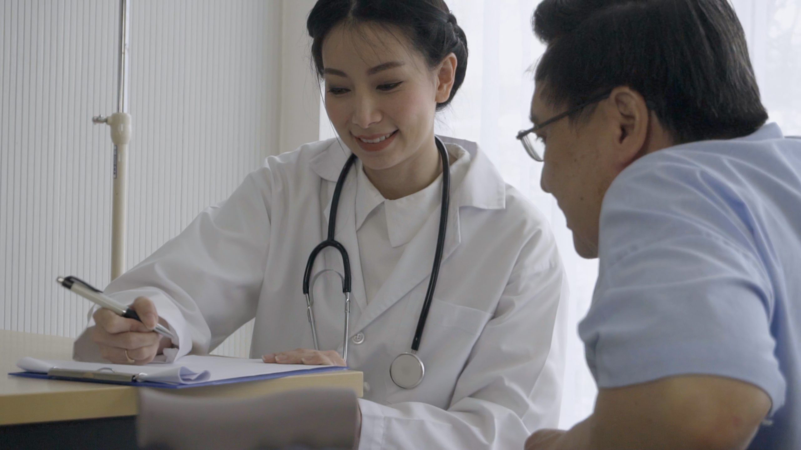 Healthcare Provider and Patient A health care provider reviews an informational chart.
