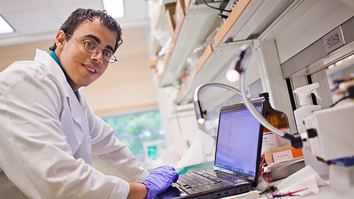 Robert Mannino Photo of Robert Mannino working on his laptop in a laboratory