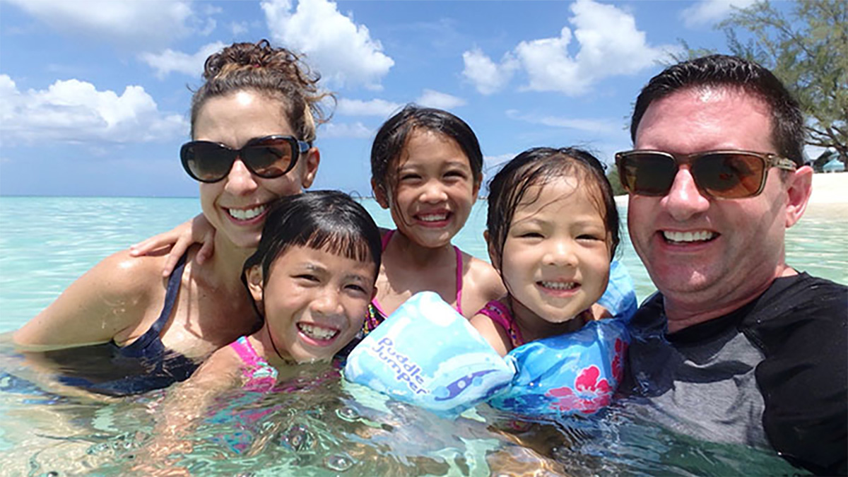 Tracy and her family Photo of Tracy Antonelli, her husband and three children posing for a picture in the ocean.