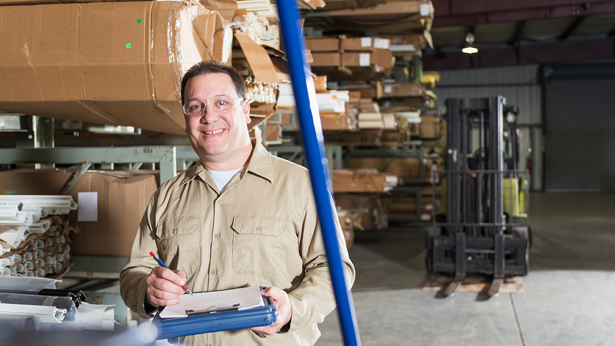 Low SES warehouse employee Man working in a large warehouse.
