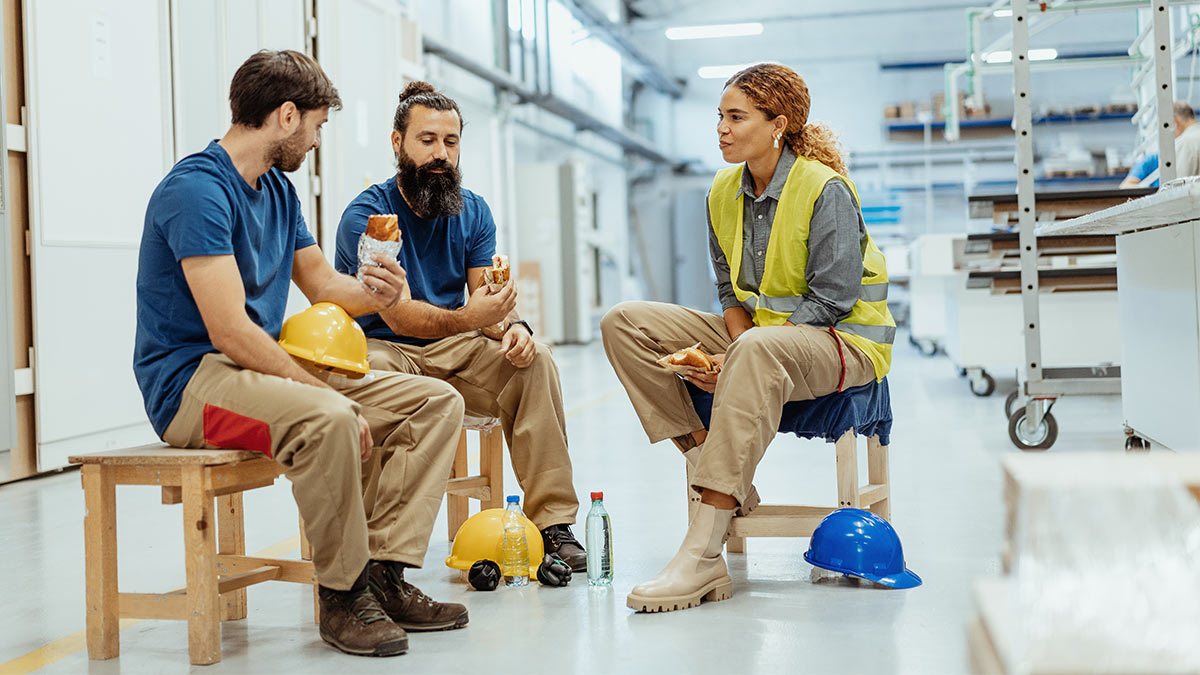 he-industrial-1200x675-1 Group of seated coworkers socializing on break