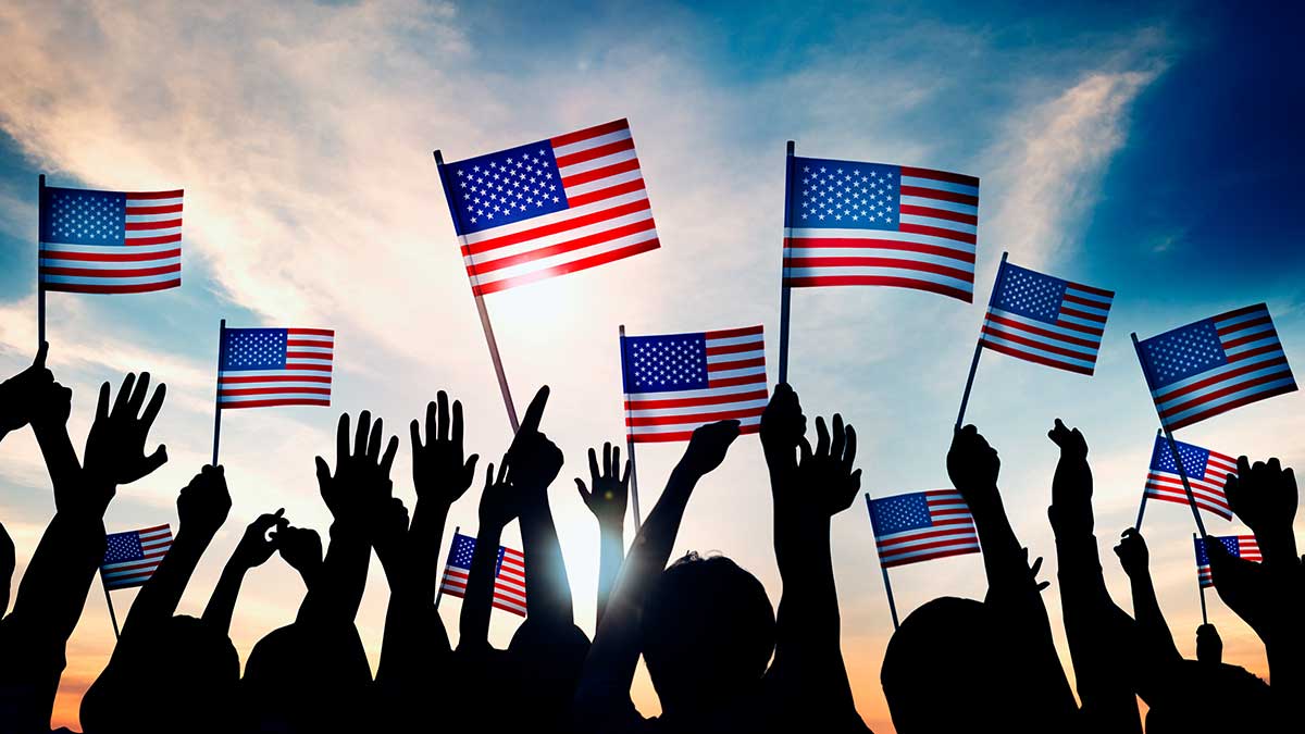 2024 Great American Smokeout People holding American flags up into the air.