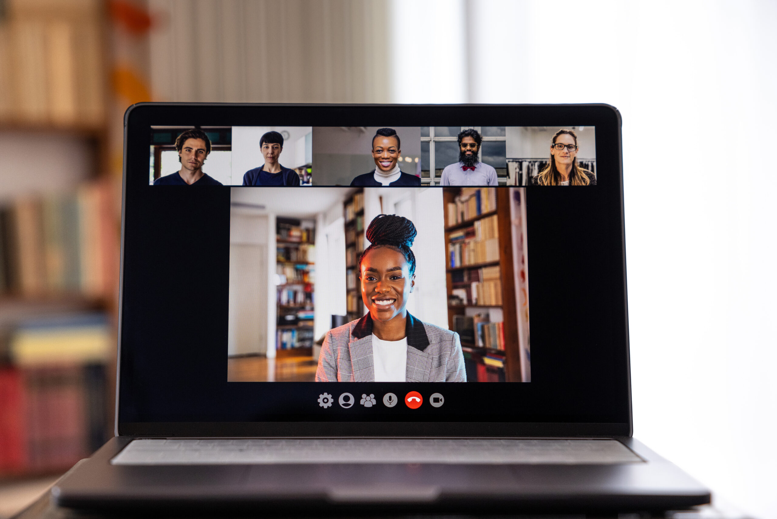 African American woman smiling on a video conference.