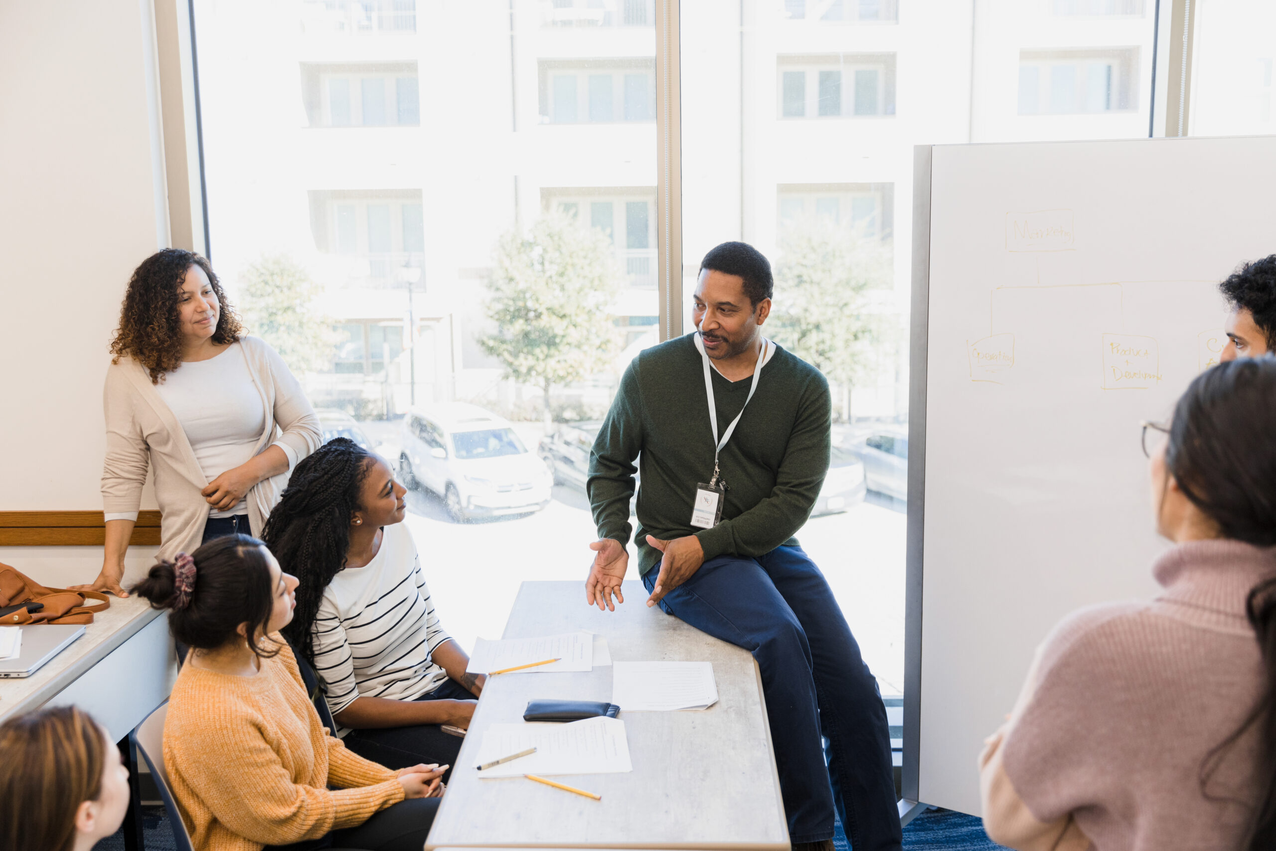 African American man leading a discussion in group setting.