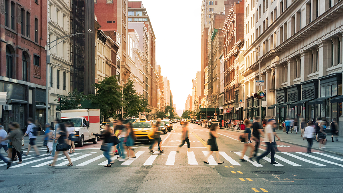 Crowds of people walking through a busy crosswalk at the intersection of 23rd Street and Fifth Avenue in Midtown Manhattan, New York City Crowds of people walking through a busy crosswalk at an intersection in Midtown Manhattan, New York City