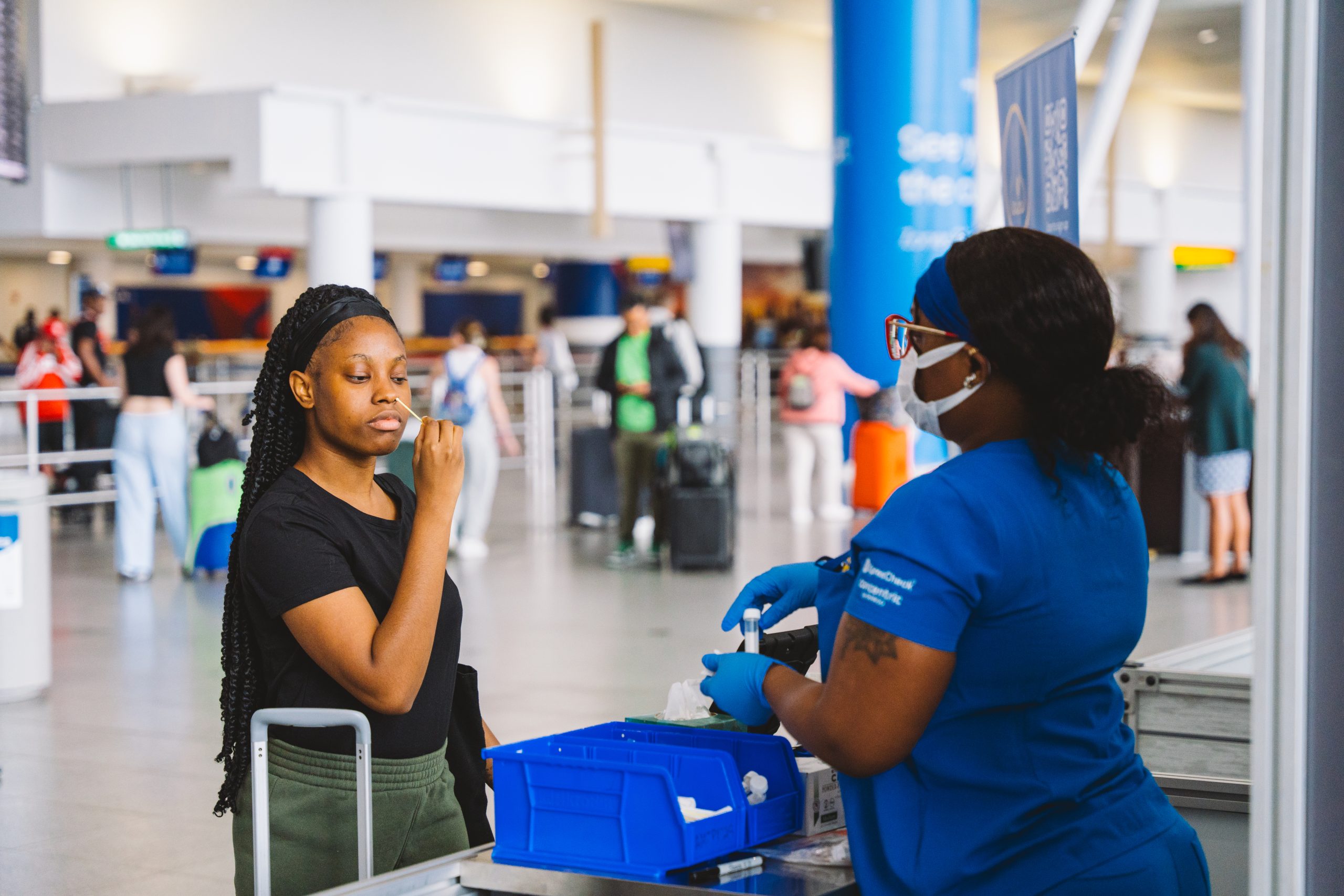 A traveler swabs their nose at a TGS testing station located at JFK International Airport.