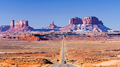 monument-valley-2lane-highway-456518943-cropped.jpg Car on highway approaching Monument Valley