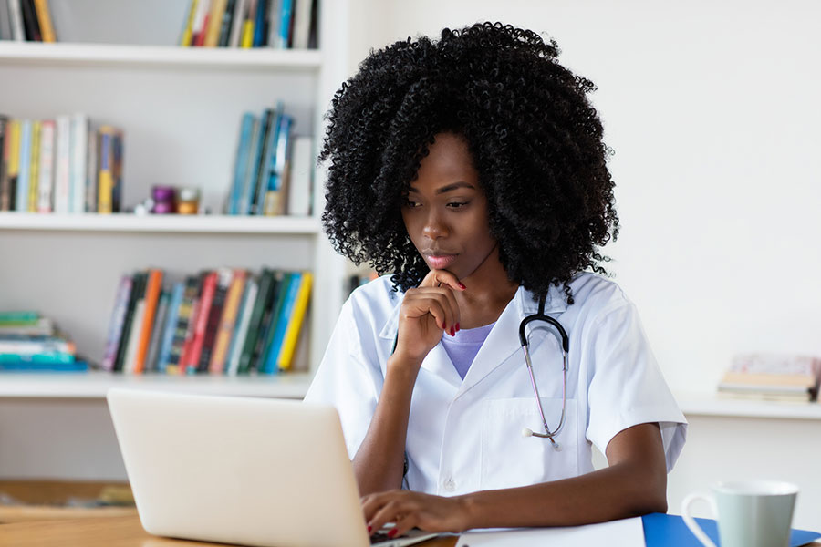 Healthcare professional at a computer.