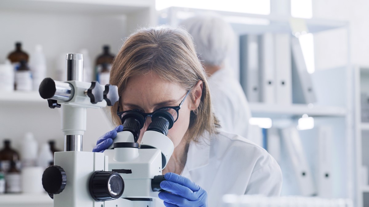 Researcher Photo of a researcher using a microscope