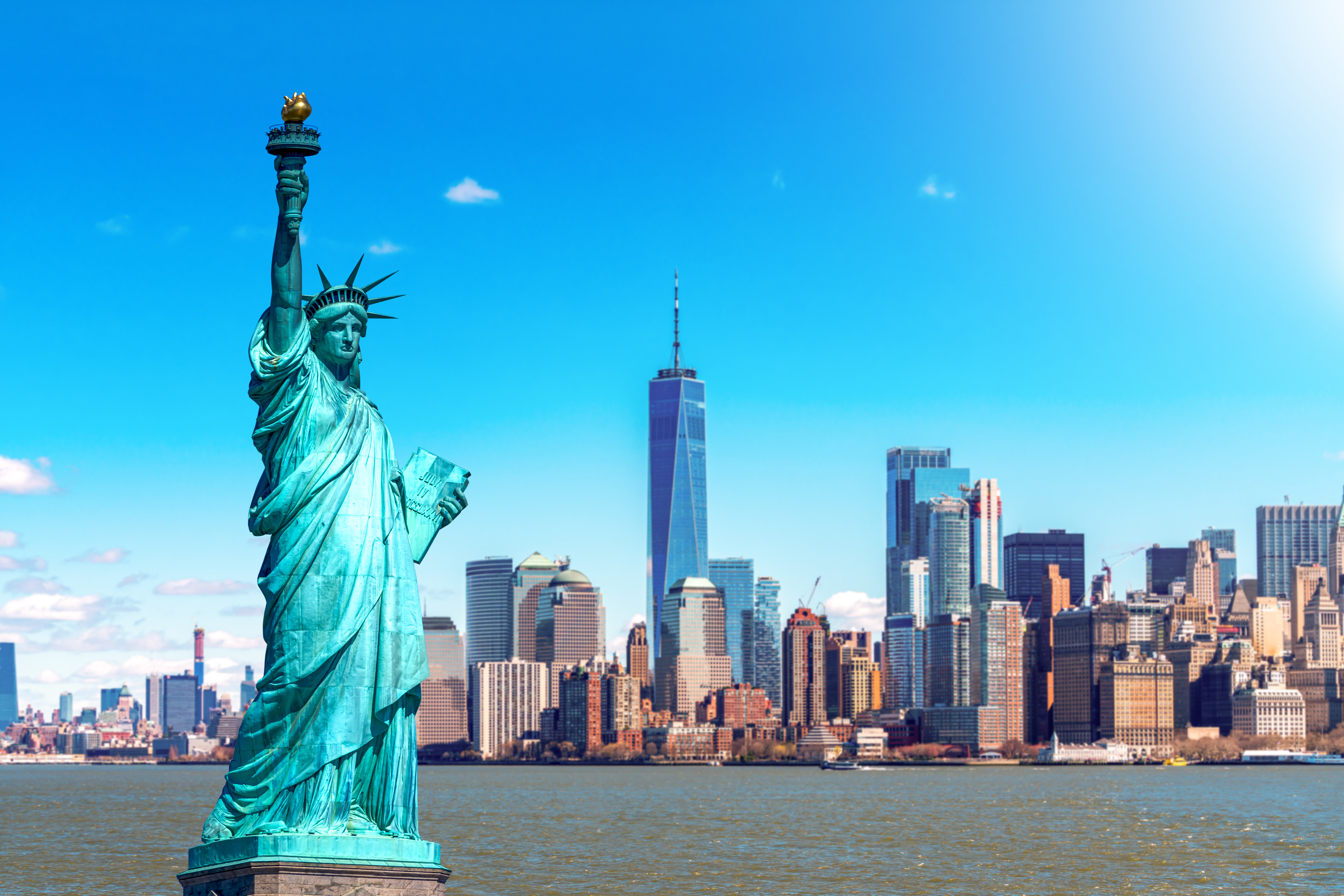 Image of New York City skyline with Statue of Liberty in the foreground.