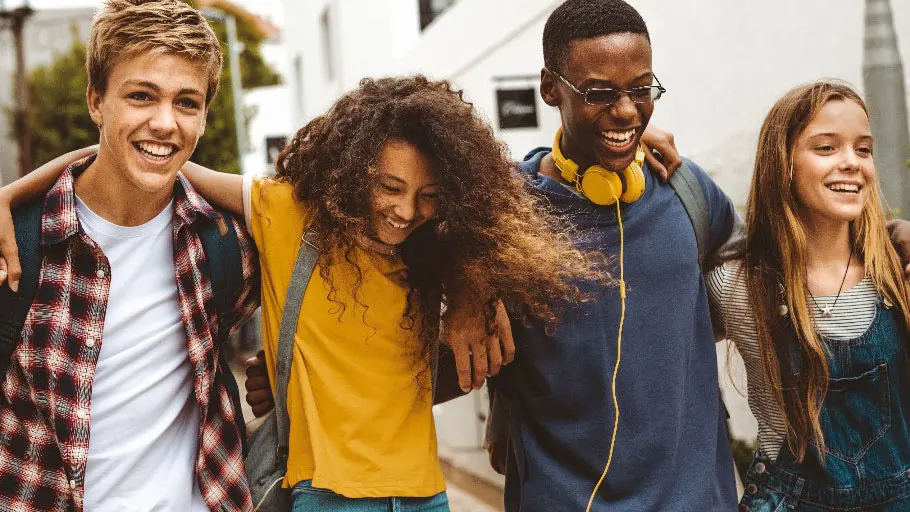 Substance Use and Sexual Risk Behaviors Four teenagers walking in a line with their arms around each other, smiling and laughing.