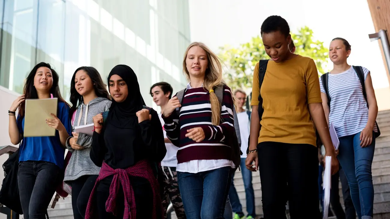 A group of high school students walking to school.