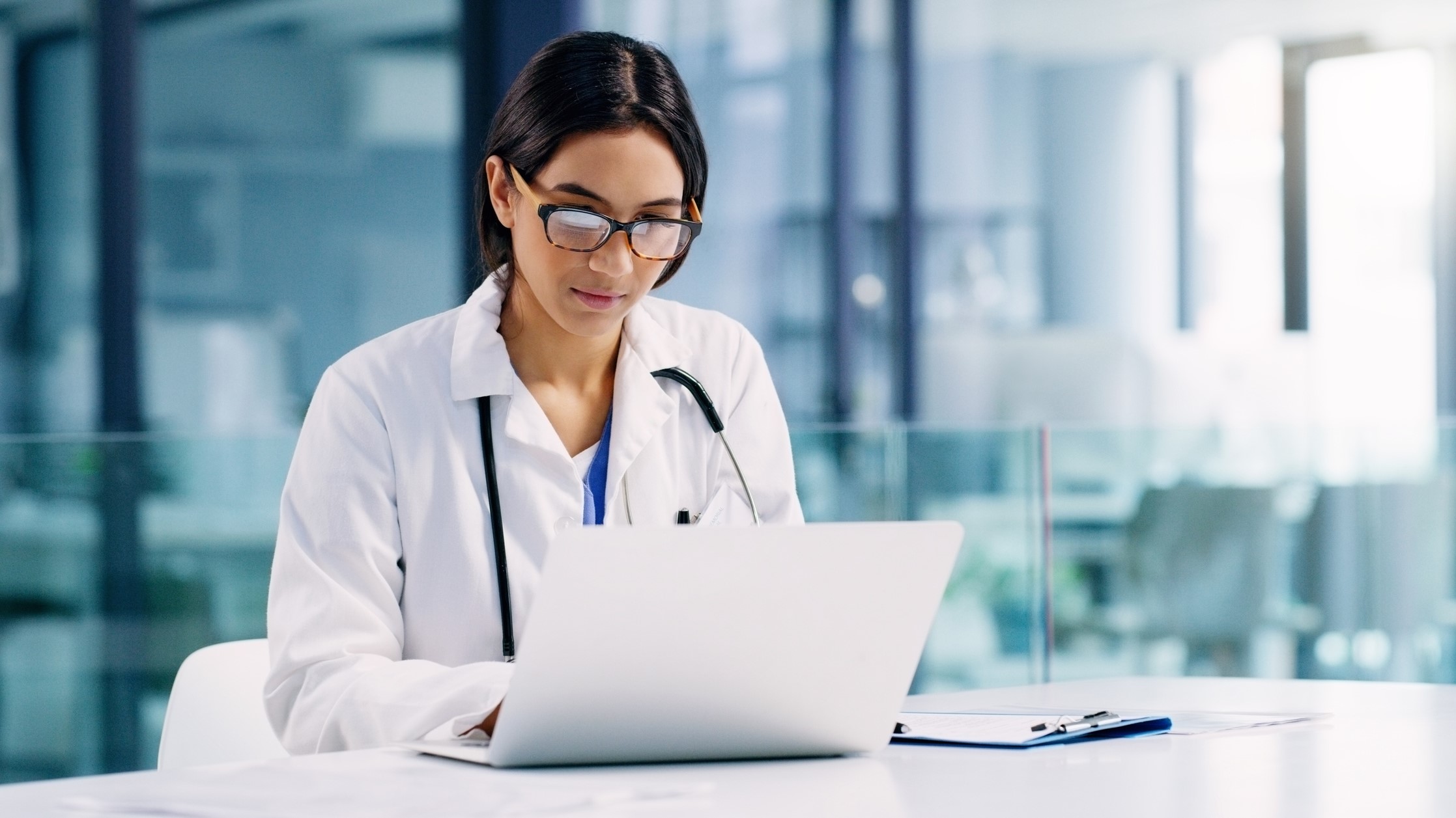 Female doctor working on her notebook computer in her office.